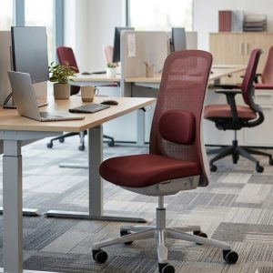 HÅG HÅG SoFi 7500 red mesh back office chair with burgundy fabric seat at modern workspace desk with laptop and monitor